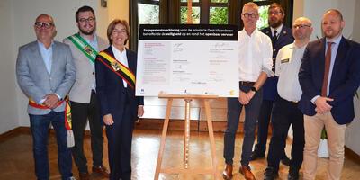 De Lijn, de politie, het openbaar ministerie, Paulo Politieopleiding, burgemeester Jo Fonck en de gouverneur van Oost-Vlaanderen tekenen de engagementsverklaring om de veiligheid op en rond het openbaar vervoer in Oost-Vlaanderen te verbeteren