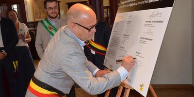 Burgemeester Jo Fonck tekent de engagementsverklaring om de veiligheid op en rond het openbaar vervoer in Oost-Vlaanderen te verbeteren